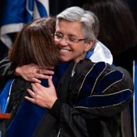 Provost and Faculty member hugging on stage